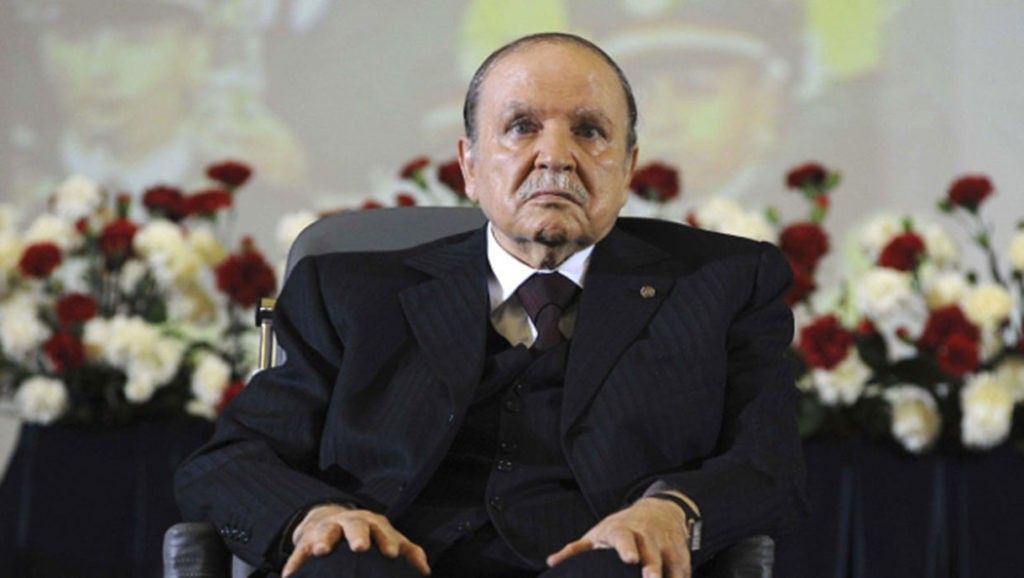 Abdelaziz Bouteflika assis sur sa chaise roulante, habillé en noir